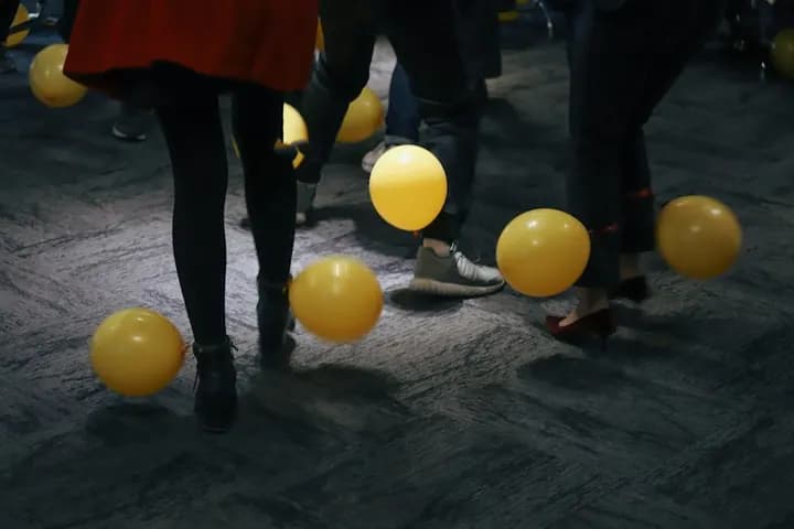 Guests dancing among balloons