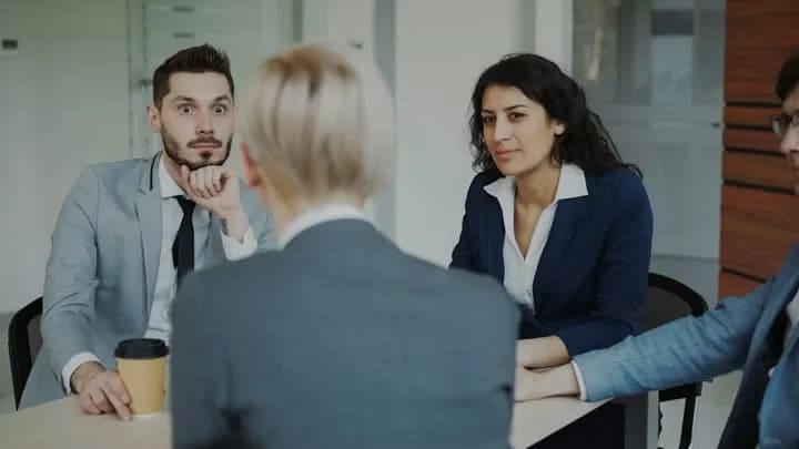Colleagues gathered around a meeting table